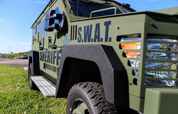 Armored vehicle with LINE-X coating
